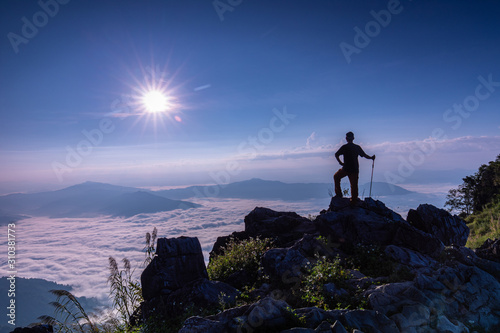 The man hiking on Doy-pha-tang, Landscape sea of mist on Mekong river in border  of  Thailand and Laos. © Nakornthai