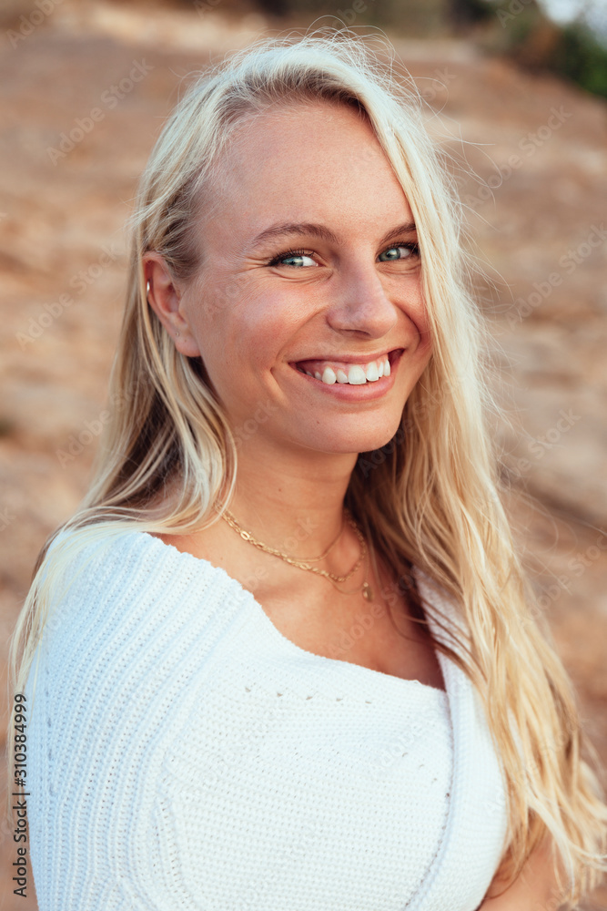 Portrait of beautiful blond woman wearing white dress Portrait of beautiful blond woman wearing white dress