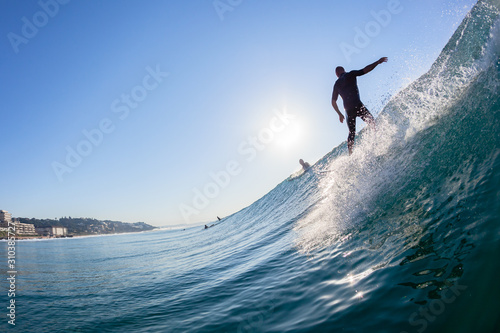 Surfer Silhouetted Surfing Wave Ride Rear Behind Water Photo © ChrisVanLennepPhoto