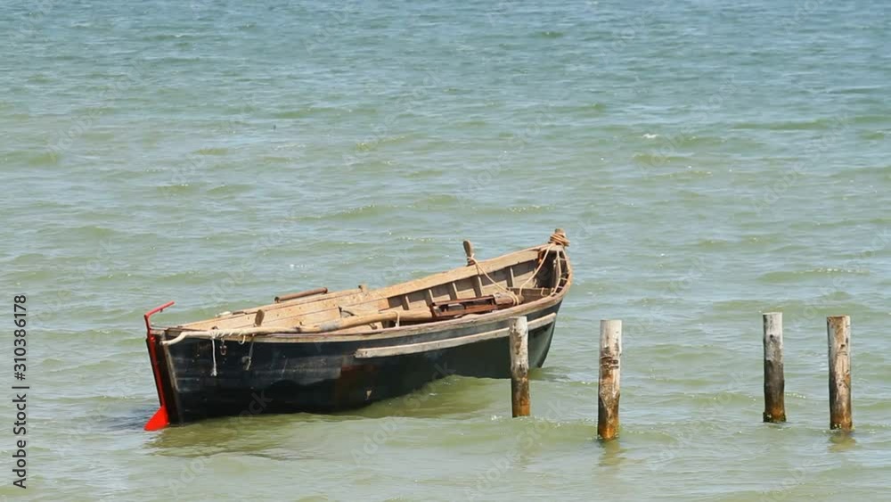 Fishing boat anchored in the blue sea Fishing boat anchored in the blue sea