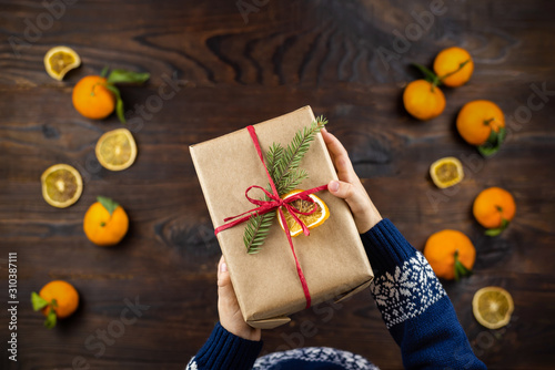 Craft gift in childres hands on wooden background photo