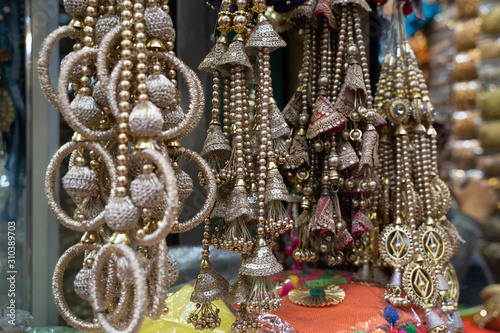 Colorful metallic decorations on display for sale in Chandi Chowk Old Delhi. These flowers, beads and bells designs are popular in weddings, festivals and events. photo