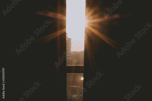 фотографія morning sunlight light ray through window curtain.