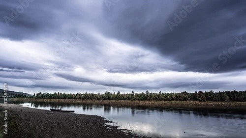 Wallpaper Mural Gray gloomy clouds flowing over the Namsen river. Calm waters, boats waiting on the shore. Torontodigital.ca