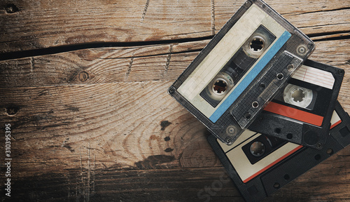 Fotografering Old audio tape compact cassettes on wooden background