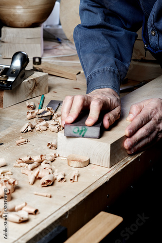 Craftsman skills concept. Woodworker in the shop. Carpenter making a pieces for the project.