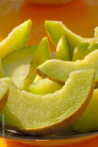 Slices of melon lie on the table.