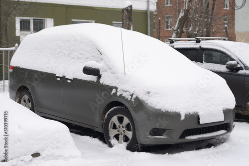 Car under snow. Snowy winter
