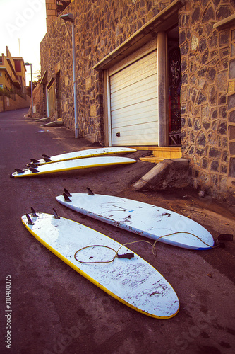 Surfboards are lying on the road in one of the streets of the famous surfing resort of El Medano, Canary Islands