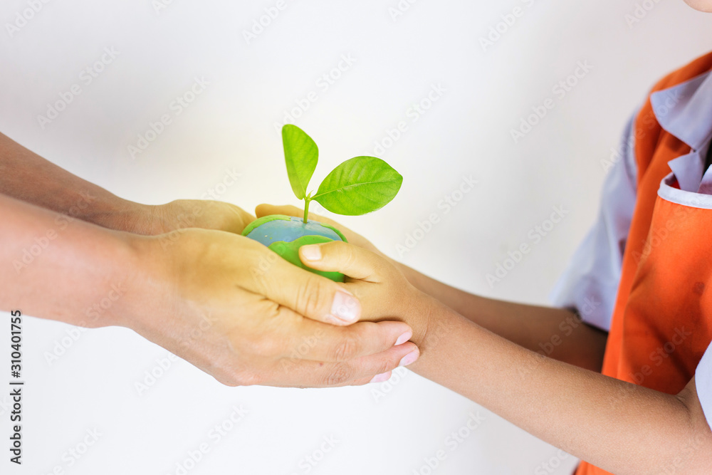 Hands children holding the world made from clay and tree on top, Eco friendly concept Hands children holding the world made from clay and tree on top, Eco friendly concept