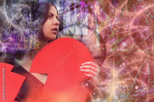 Woman holds broken heart in her hands and looks forward