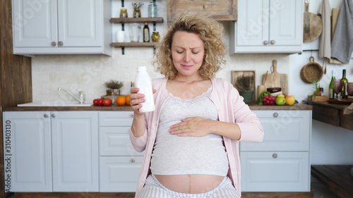 Pregnant Woman Taking Medicine Against Heartburn