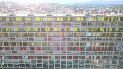 Accending shot over colorful apartment blocks with a city center reveal. photo