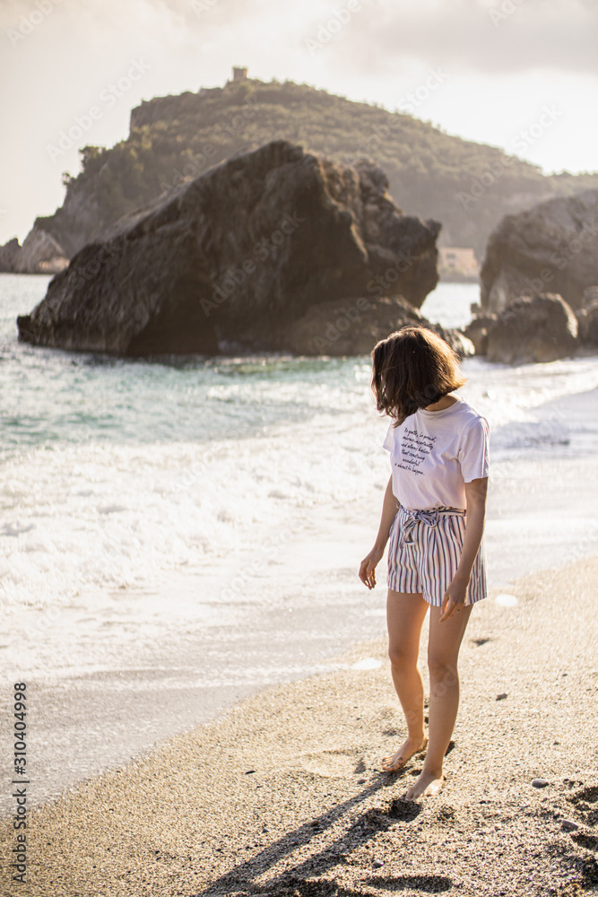 Woman walking on a beach coast