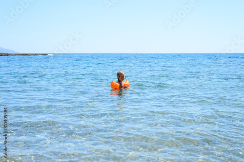 little girl having fun at summer vacation in sea