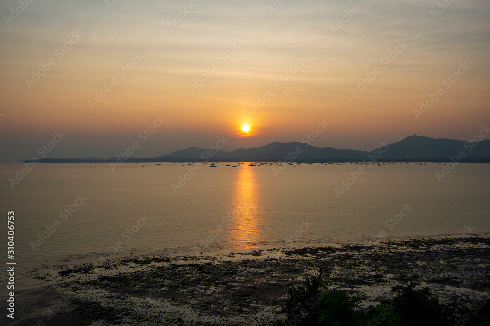 The sun sets on beautiful beach in Thailand, Phuket.