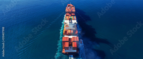 Aerial drone photo of industrial cargo container carrier cruising the open ocean deep blue sea