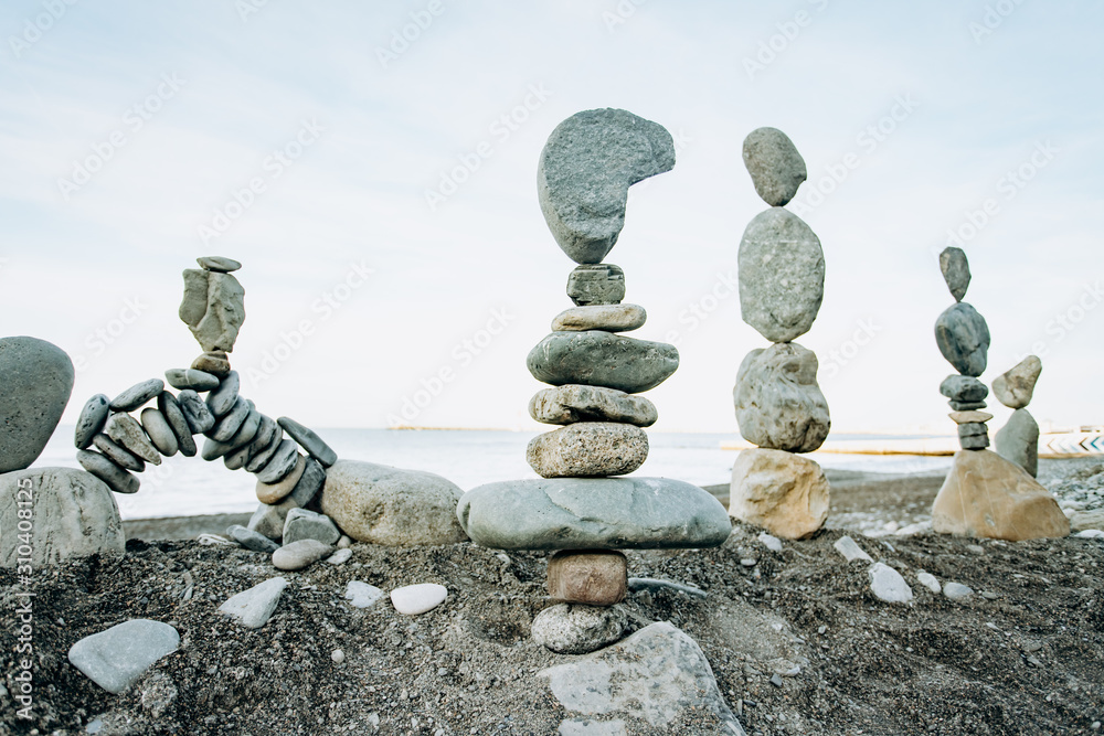 Infinitely stacked stones and stone figures by the sea