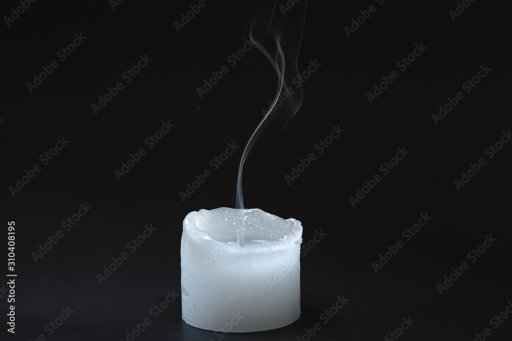 Smoke rising from a dipped candle. Blue smoke of a candle in dark