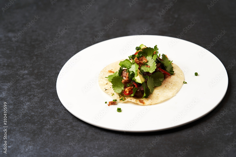 Mexican tacos with beef, tomatoes, avocado, chilli and onion Mexican tacos with beef, tomatoes, avocado, chilli and onion
