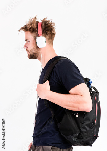 Student handsome guy listening music. Man tousled hairstyle wear plastic earphones gadget. Enjoy music everywhere you go. Rhythmic melody concept. Download music application. Youth music taste