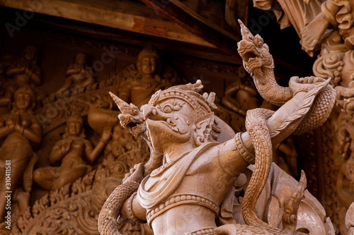 wooden garuda and naga on temple in Thailand .