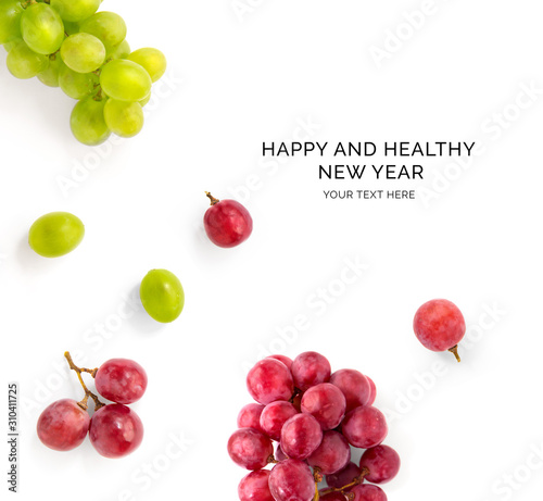 Valokuva Creative happy and healthy new year card made of grapes on the white background