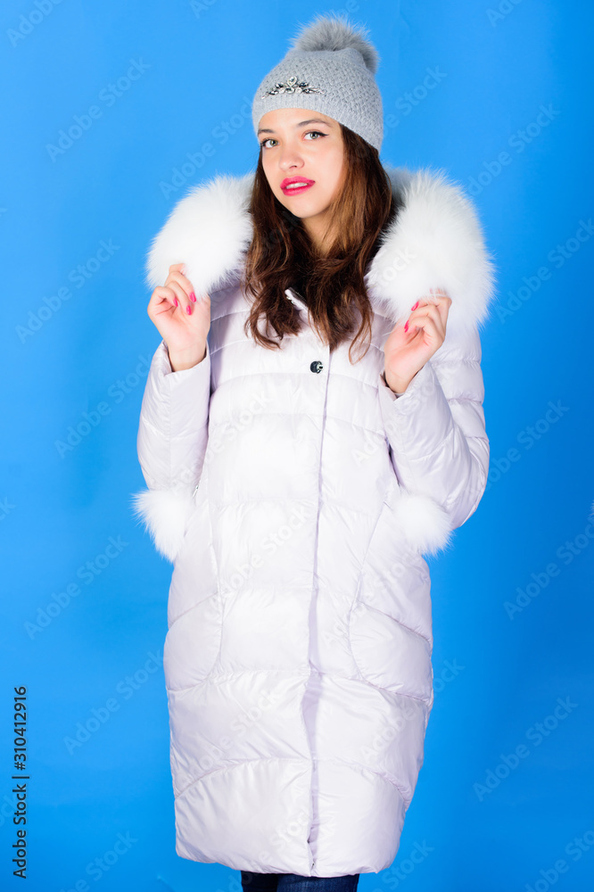 Obraz premium Fashion trend. Winter season of contrasts. Style code with elegance. For those wishing stay modern. Winter clothes. Woman wear down jacket. Warm and cozy. Girl wear winter jacket blue background