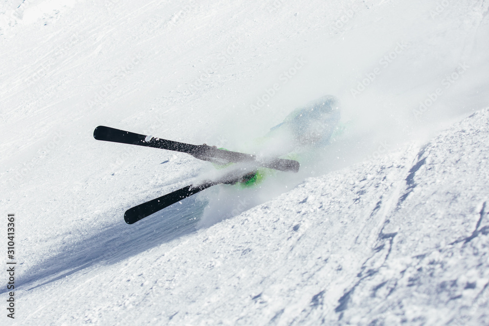 Skier skiing downhill during sunny day in high mountains Skier skiing downhill during sunny day in high mountains