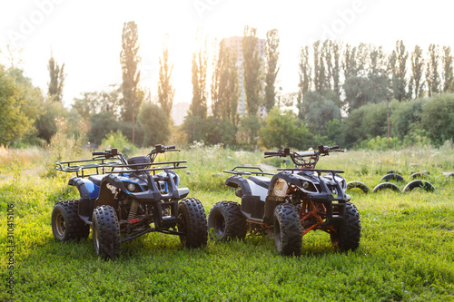 two ATVs stand in the field