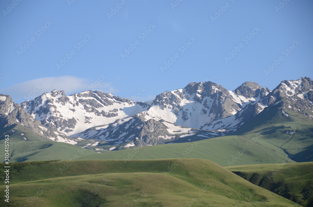 panorama of kyrgysian mountains with meadow in foreground panorama of kyrgysian mountains with meadow in foreground