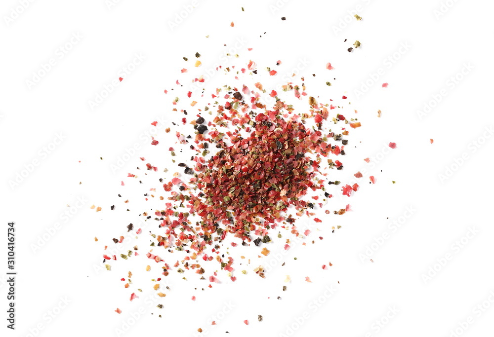 Colorful ground mixed pepper grains, flakes isolated on white background, top view