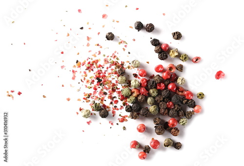 Colorful mixed pepper grains and flakes, isolated on white background, top view photo