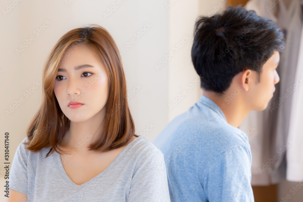 Relationship of young asian couple having problem on bed in the bedroom at home, family having conflict argument with unhappy, man and woman with issue, failure and stress together. Relationship of young asian couple having problem on bed in the bedroom at home, family having conflict argument with unhappy, man and woman with issue, failure and stress together.