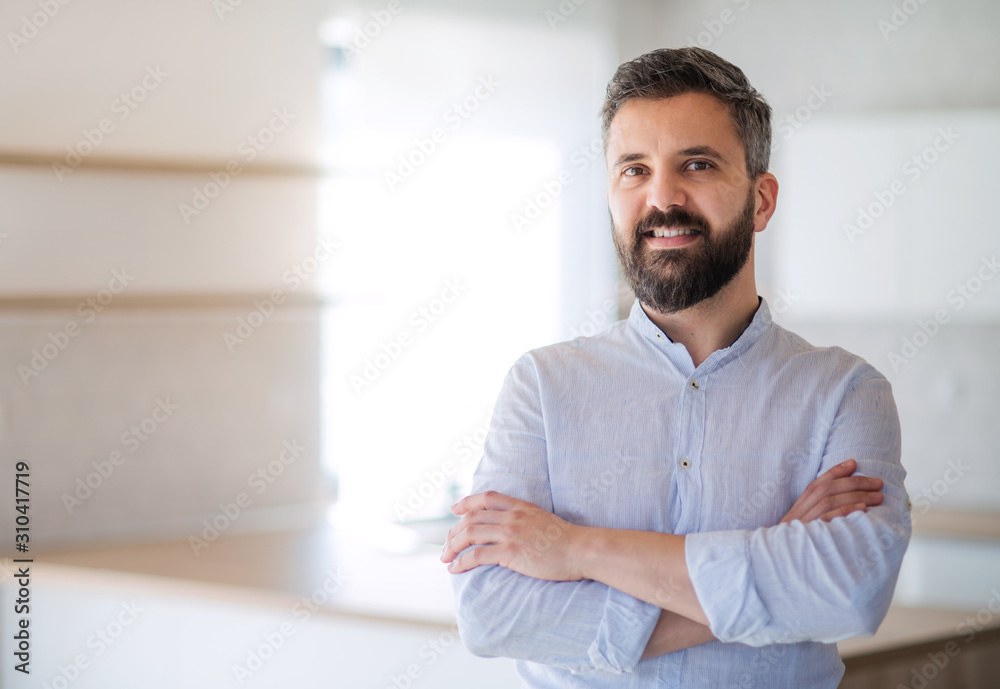 Mature man standing in house, moving in new home concept. Mature man standing in house, moving in new home concept.