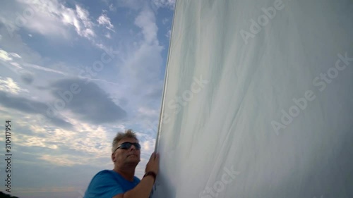 Middle-aged man sailing on the Masurian Lake in Poland