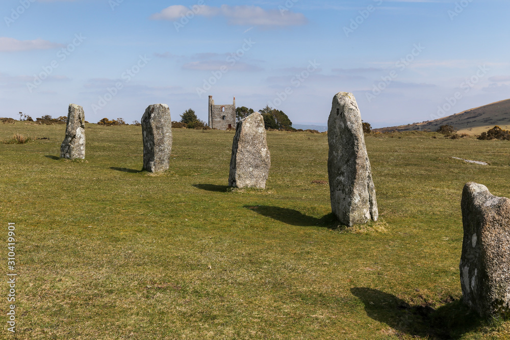 The Hurlers Stone Circle with abandoned Tin mine in the background near Minions in Cornwall on Bodmin Moor