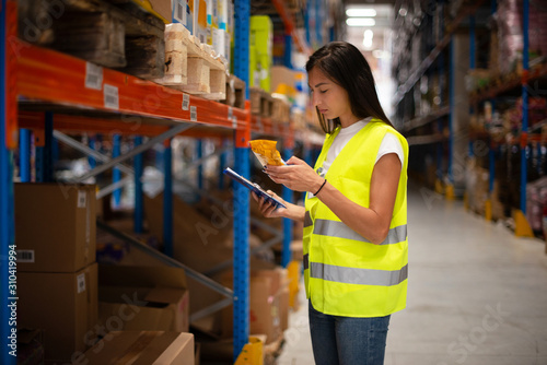 Workers in warehouse review the goods