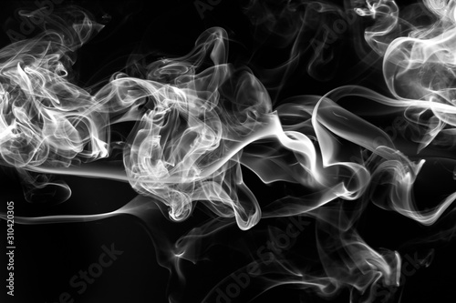 Smoke the white incense on a black background. fire design
