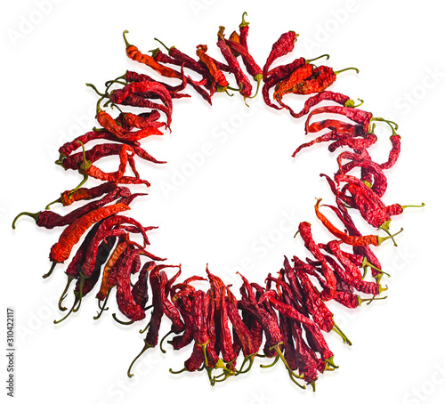 Wreath of dried chili pepper on a white background