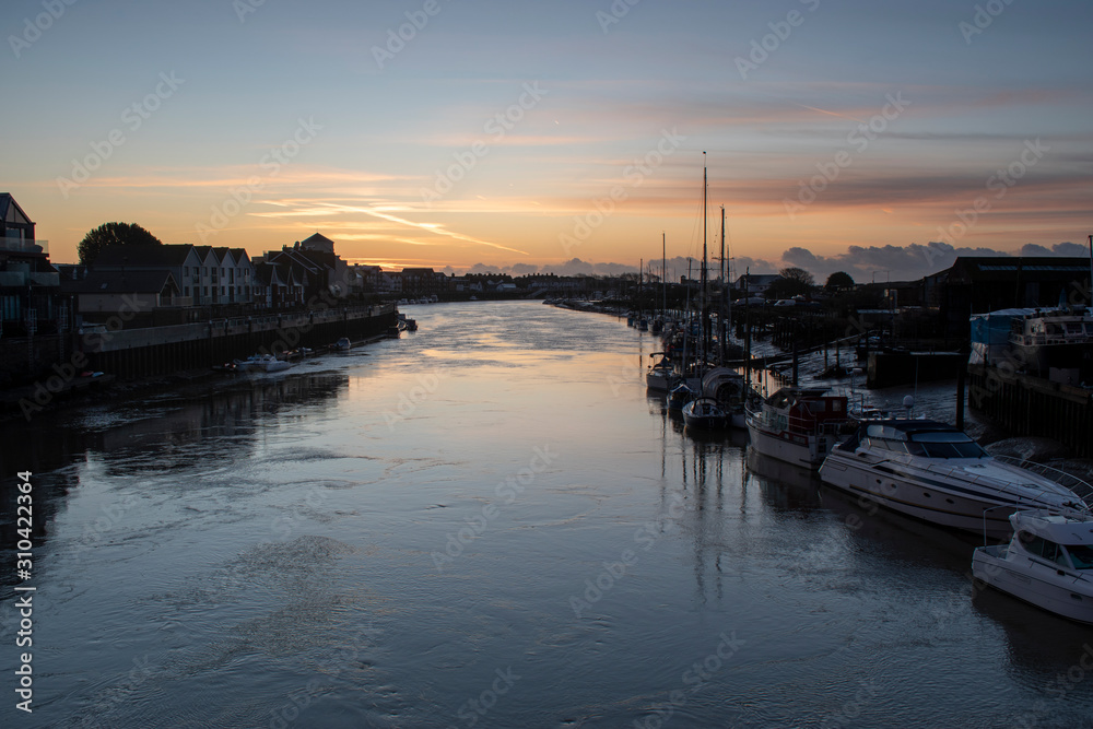 Morning Sunrise The River Arun Littlehampton with yachts and boats in the foreground, a calm and peaceful scene.