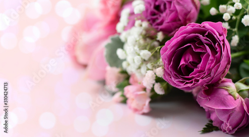 beautiful closeup rose bouquet containing pink rose flowers and leaves and branch of gypsophila for decoration