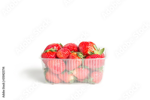 Fresh red strawberries in a plastic transparent container