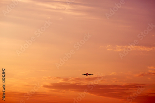 Airplane taking off and flying high in sunset sky © dariazu
