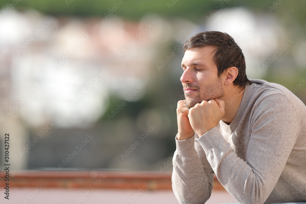 Relaxed man with closed eyes enjoying the sun Relaxed man with closed eyes enjoying the sun