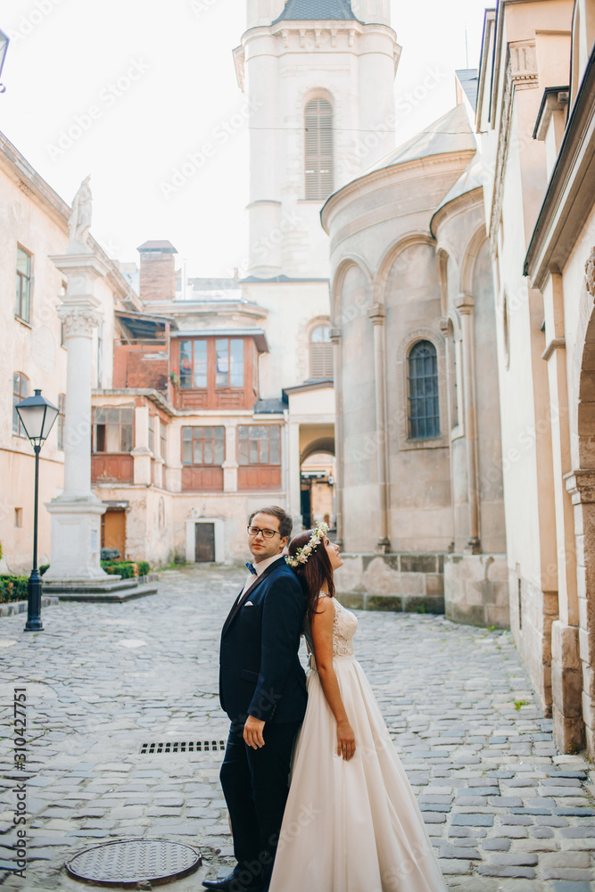 Bride and groom walking through the old town