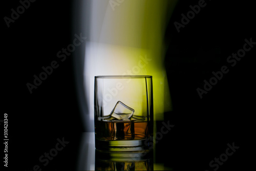 glass of whiskey in spotlight background © Vladimir