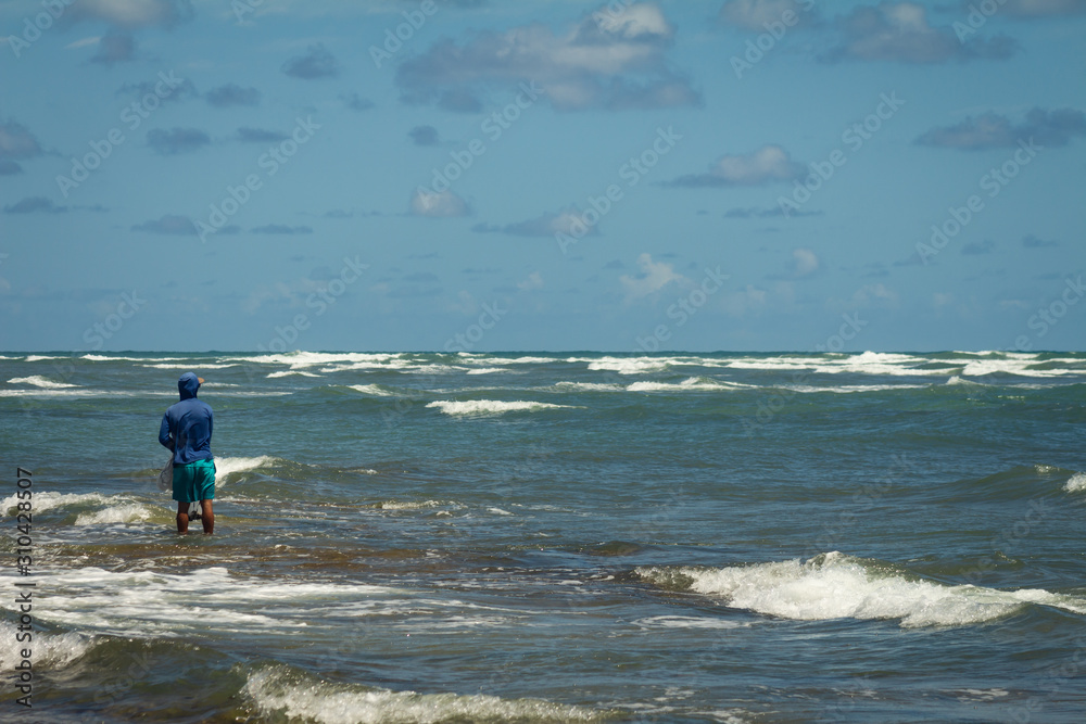 Fisherman on the edge of the sea. Coastal landscape. Fisherman on the edge of the sea. Coastal landscape.