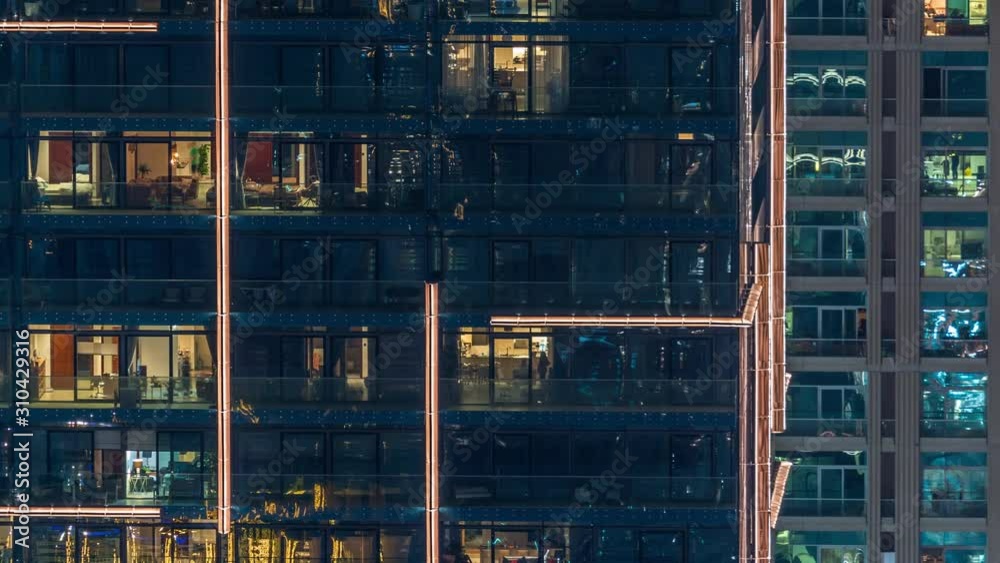 Lights in windows of modern multiple story building in urban setting at night timelapse. Glowing lights in residential skyscraper in Dubai Marina Lights in windows of modern multiple story building in urban setting at night timelapse. Glowing lights in residential skyscraper in Dubai Marina