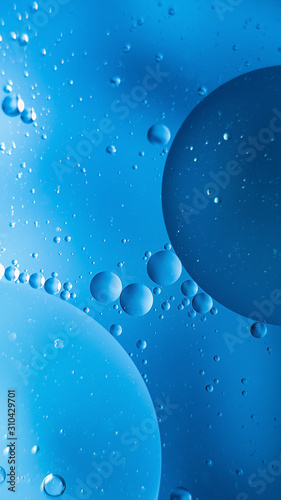 oil with bubbles on on dark blue background. Abstract background.